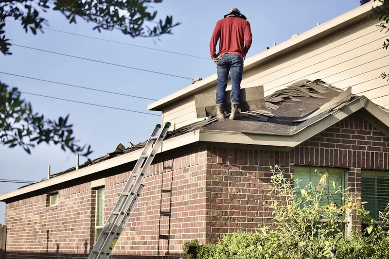 Professional roofer working on a residential roof in Quinlan